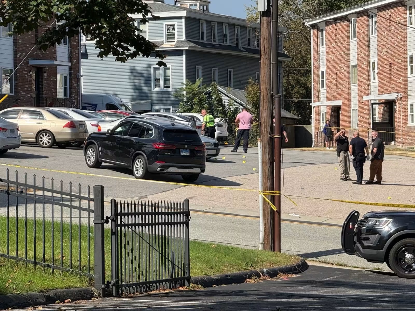 Investigators at the taped-off scene on Garfield Avenue.