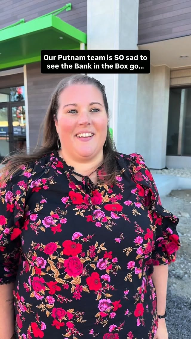A still from Centreville Bank’s October reopening video shows a Putnam team member outside the branch, announcing its return from temporary banking space.