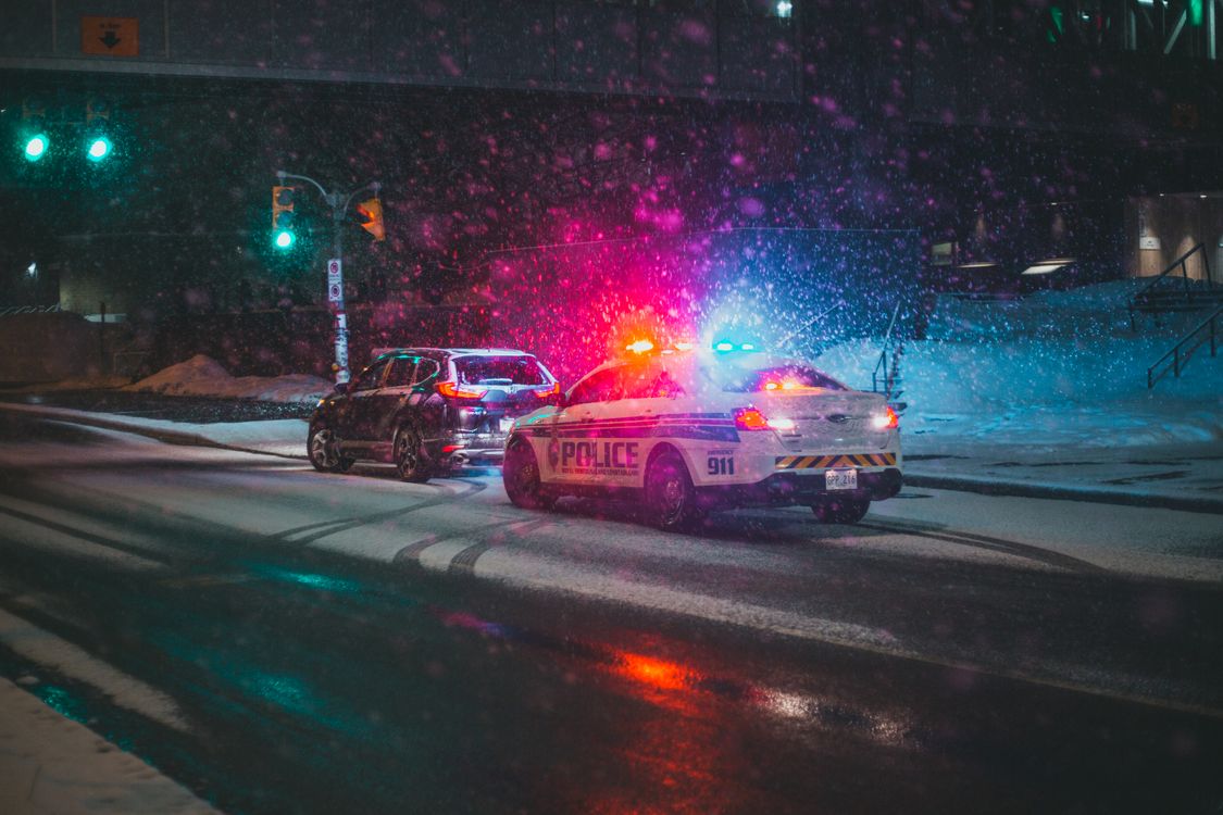 Generic file photo of a stopped SUV with a police car behind it at night; not this story's people, location or event